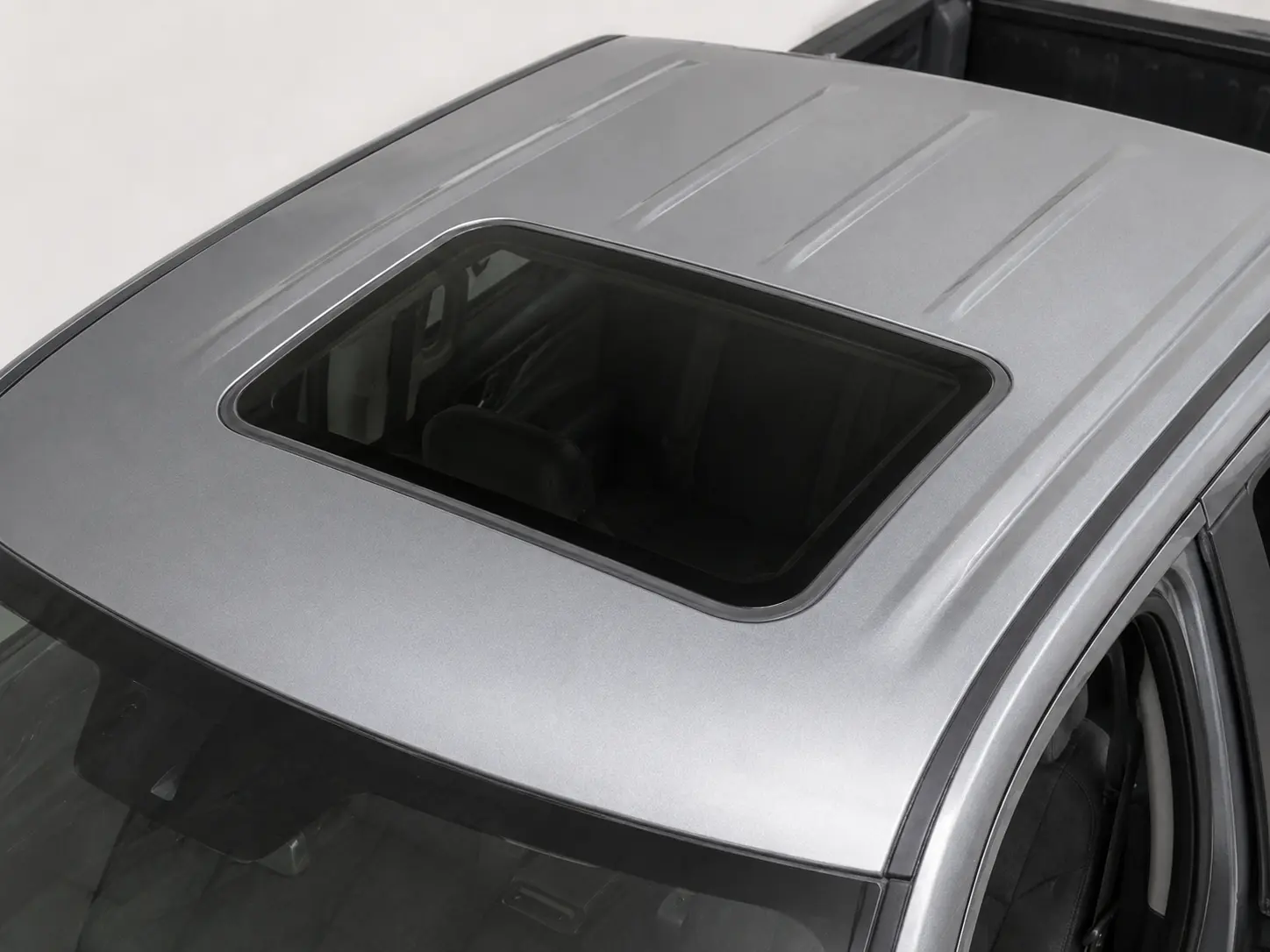 Aftermarket moonroof opening cut into a vehicle roof