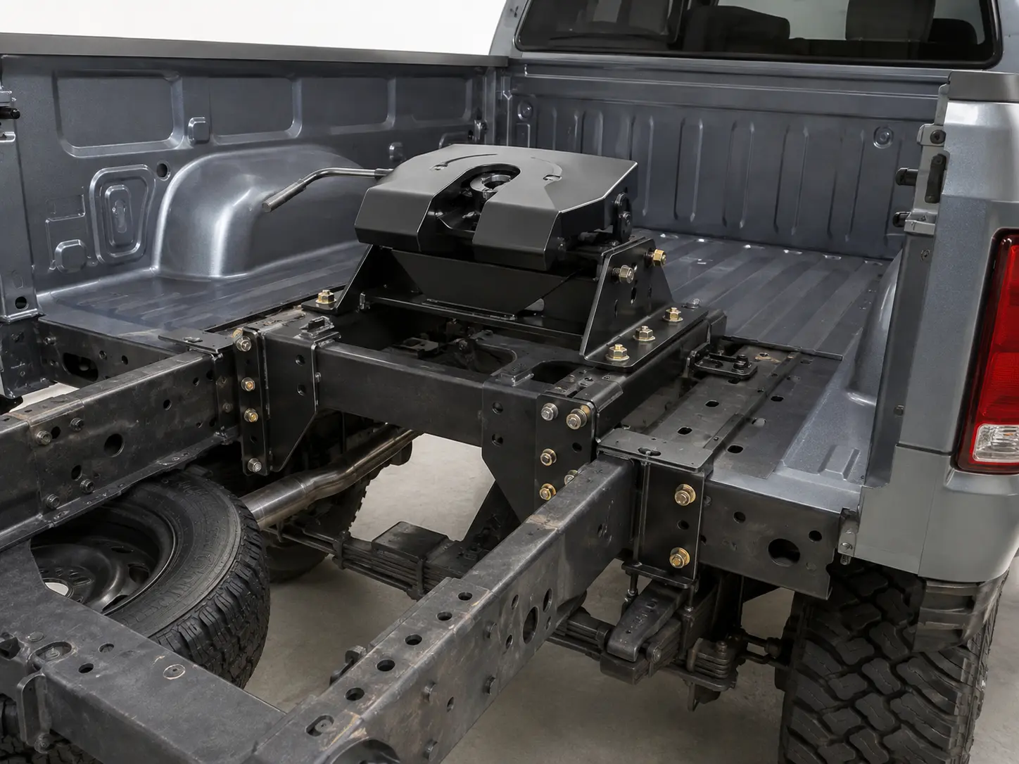 Fifth wheel hitch mounted through the bed and frame rails